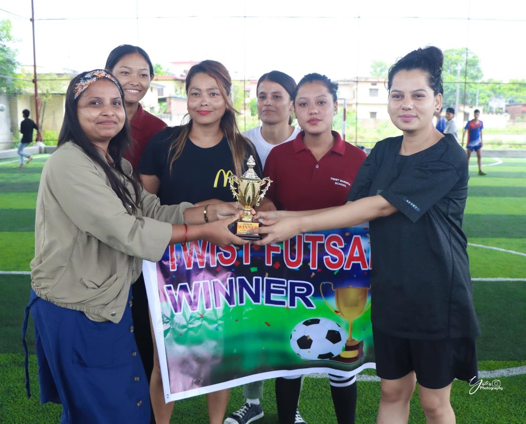 Twist Futsal Girls Winner team holding trophy and banner