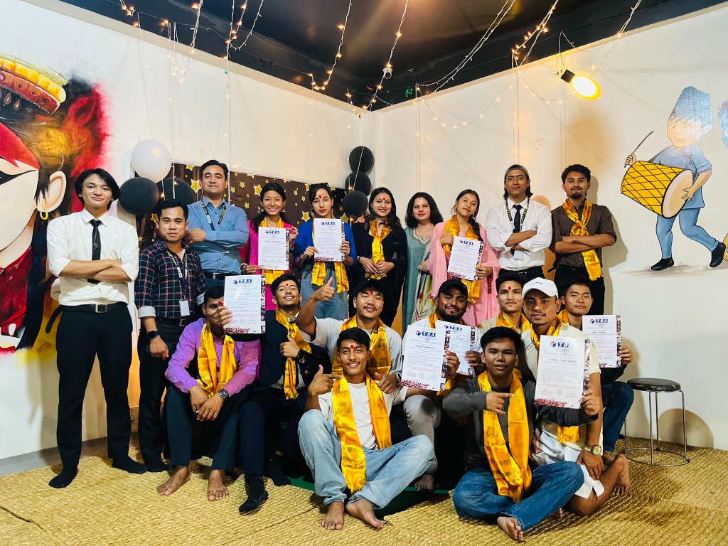 Graduates proudly holding certificates at Twist Academy celebration