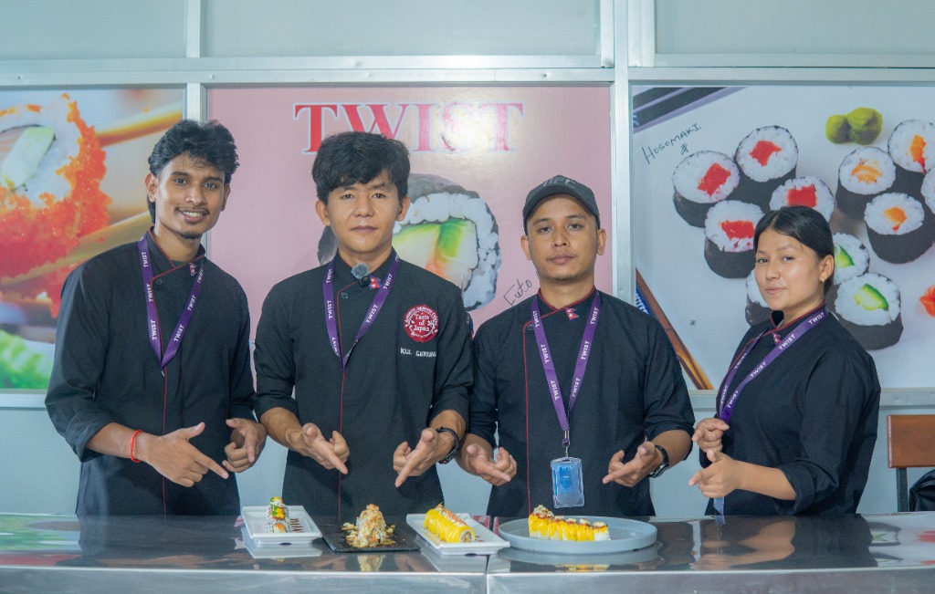 Students showing plated specialty sushi rolls